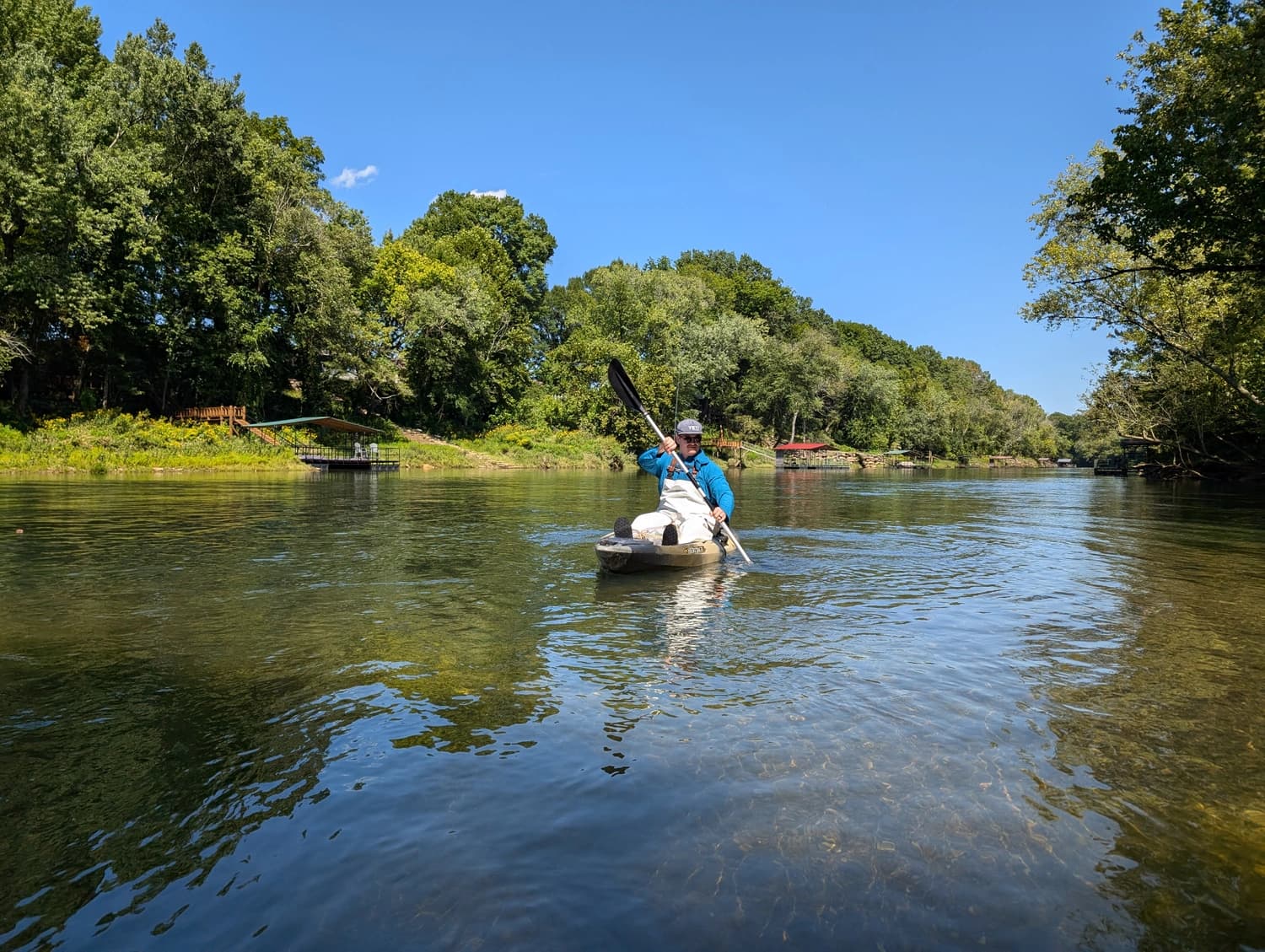 Kayaker paddling on a clear river near Searcy