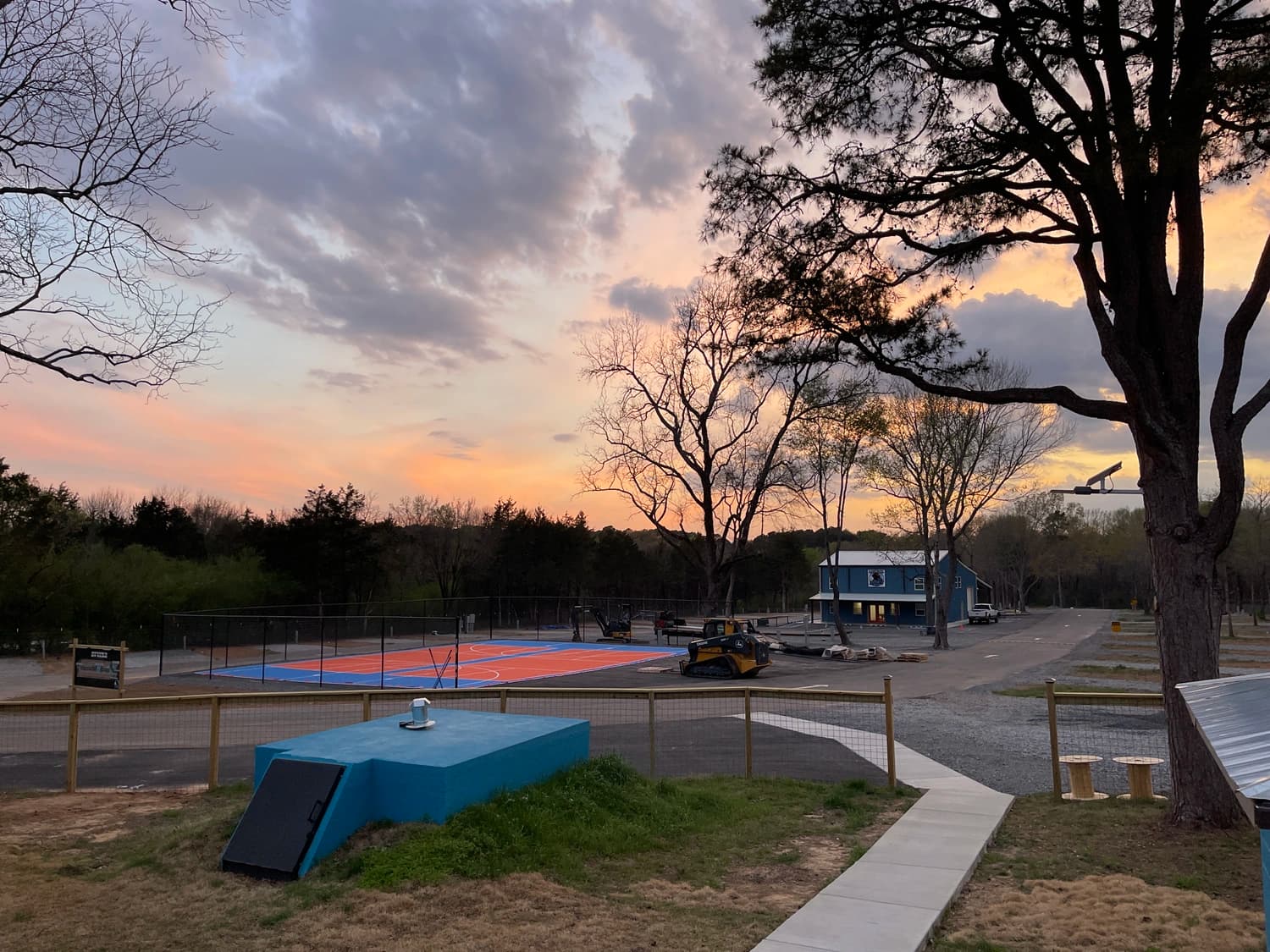 Sunset over pickleball courts and store at Hutch's RV Park