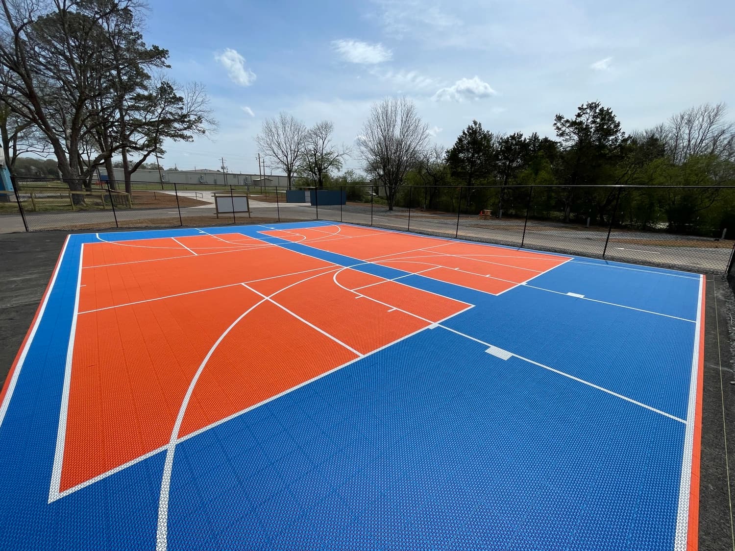 Orange and blue pickleball and basketball courts